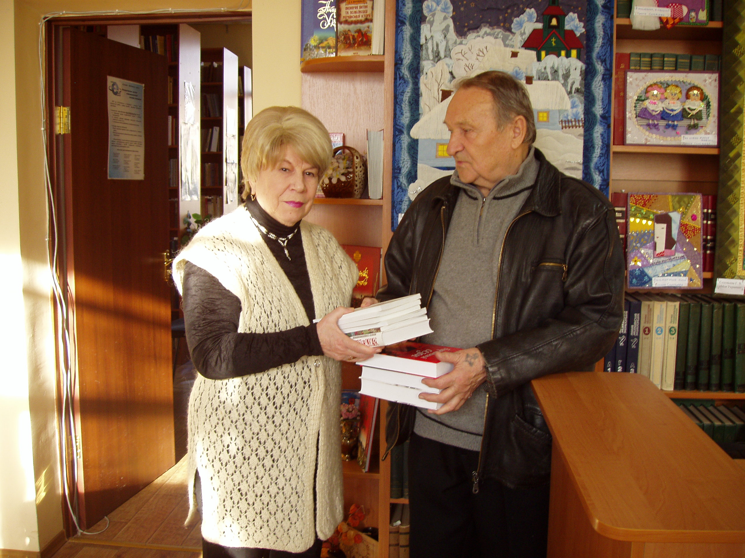 В. М. Омельченко вручає книги в дар бібліотеці